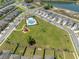 A scenic aerial view of the community park, pool, and surrounding homes, offering a serene and Gathering-friendly environment at 7580 Freesia Trce, Wesley Chapel, FL 33545