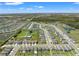 An aerial view showcasing the extensive neighborhood, lakes, and community layout under a clear sky at 7580 Freesia Trce, Wesley Chapel, FL 33545
