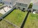 Aerial view of a spacious backyard with a well-maintained lawn and privacy fence, perfect for outdoor activities at 7580 Freesia Trce, Wesley Chapel, FL 33545