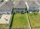 Aerial view of a spacious backyard with a well-maintained lawn and privacy fence, perfect for outdoor gatherings at 7580 Freesia Trce, Wesley Chapel, FL 33545