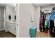 Bathroom with sink, granite countertops, an adjacent closet, and is well-organized with clothing racks and storage at 7580 Freesia Trce, Wesley Chapel, FL 33545