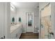 Bathroom with double sinks, granite countertops, and a shower/tub, providing a clean and modern space at 7580 Freesia Trce, Wesley Chapel, FL 33545