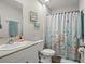 Charming bathroom with shower and tub, ocean-themed decor, sink, and toilet at 7580 Freesia Trce, Wesley Chapel, FL 33545
