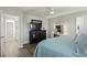 Comfortable bedroom featuring a dresser with a TV and a vanity with a mirror and bright lighting at 7580 Freesia Trce, Wesley Chapel, FL 33545