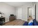 A bright bedroom features a closet, an ensuite bathroom, and hardwood floors at 7580 Freesia Trce, Wesley Chapel, FL 33545