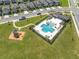 Aerial view of the community pool, playground, and surrounding landscaped area at 7580 Freesia Trce, Wesley Chapel, FL 33545