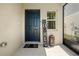 Inviting entryway featuring a stylish black door and decorative welcome sign at 7580 Freesia Trce, Wesley Chapel, FL 33545