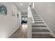Hallway featuring hardwood floors, stairs, and decoratively painted walls at 7580 Freesia Trce, Wesley Chapel, FL 33545