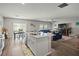 Bright, open kitchen featuring quartz countertops, stainless sink, and modern appliances at 7580 Freesia Trce, Wesley Chapel, FL 33545