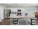 Spacious kitchen featuring an island with seating and modern stainless steel appliances at 7580 Freesia Trce, Wesley Chapel, FL 33545