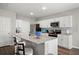 Well-lit kitchen with an island featuring seating and stainless steel appliances at 7580 Freesia Trce, Wesley Chapel, FL 33545