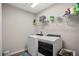 Bright laundry room featuring a modern washer and dryer at 7580 Freesia Trce, Wesley Chapel, FL 33545