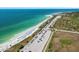 Breathtaking aerial view of beach access, azure waters, and white sandy shoreline at 762 Marjon Ave, Dunedin, FL 34698