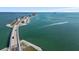 Dramatic aerial shot of the causeway and azure Gulf waters with boats cruising through the tranquil sea at 762 Marjon Ave, Dunedin, FL 34698