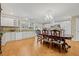 Spacious kitchen featuring granite counters, white cabinets, and a dining table with decorative chairs at 762 Marjon Ave, Dunedin, FL 34698