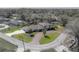 Wide aerial view of a large home on a corner lot with a long driveway and mature trees at 7922 Spring Valley Dr, Tampa, FL 33615
