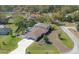 Sprawling property featuring a private pool, brick driveway, and lush green landscaping at 7922 Spring Valley Dr, Tampa, FL 33615