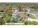 Aerial shot of a large property with a pool, mature landscaping, and a basketball court at 7922 Spring Valley Dr, Tampa, FL 33615