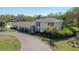 Traditional two-story home with a brick facade, lush greenery, and a circular driveway at 7922 Spring Valley Dr, Tampa, FL 33615