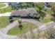 Spacious home with a long, brick driveway and lush landscaping in a serene neighborhood setting at 7922 Spring Valley Dr, Tampa, FL 33615