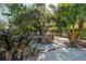 Picturesque backyard featuring a gazebo, patio dining set, stone landscaping, and mature trees, ideal for relaxation and gatherings at 7922 Spring Valley Dr, Tampa, FL 33615