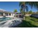 Poolside with a covered outdoor kitchen, and landscaped backyard at 7922 Spring Valley Dr, Tampa, FL 33615
