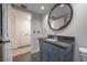 Well-lit bathroom featuring a vanity with a granite countertop and decorative cabinet at 7922 Spring Valley Dr, Tampa, FL 33615
