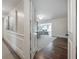 Open doorway revealing a bedroom and a living area with hardwood floors and a modern chandelier at 7922 Spring Valley Dr, Tampa, FL 33615