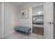 Stylish entryway with a blue bench, tile floors, and a view into a beautifully decorated bedroom with a chandelier at 7922 Spring Valley Dr, Tampa, FL 33615