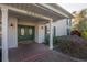 Elegant double front door entrance with brick paving, well-lit sconces, and lush shrubs at 7922 Spring Valley Dr, Tampa, FL 33615