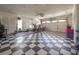 Spacious garage with checkered floors, exercise equipment, and ample storage at 7922 Spring Valley Dr, Tampa, FL 33615