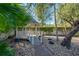 Charming gazebo with a bridge entrance, surrounded by stone landscaping and shade trees, offering a peaceful retreat at 7922 Spring Valley Dr, Tampa, FL 33615