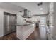 Bright kitchen featuring a large island, stainless steel appliances, and dark hardwood floors at 7922 Spring Valley Dr, Tampa, FL 33615