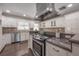 Kitchen with stainless steel appliances, granite countertops, white cabinets, and brick backsplash at 7922 Spring Valley Dr, Tampa, FL 33615