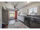 Bright laundry room features dark wood floors, white cabinetry, and modern washer and dryer at 7922 Spring Valley Dr, Tampa, FL 33615