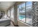 Living room window overlooking a private backyard pool and patio area at 7922 Spring Valley Dr, Tampa, FL 33615