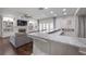 Living room with marble countertop bar, fireplace, built-in shelves, and hardwood floors at 7922 Spring Valley Dr, Tampa, FL 33615