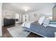 Spacious main bedroom with a modern chandelier, dark wood floors, and direct access to the ensuite bathroom at 7922 Spring Valley Dr, Tampa, FL 33615