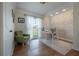 Bright office space with hardwood floors, stylish wallpaper, and an exterior view at 7922 Spring Valley Dr, Tampa, FL 33615
