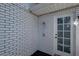 Outdoor shower area with white brick and door at 7922 Spring Valley Dr, Tampa, FL 33615