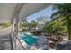 View of the pool and patio area with mature landscaping at 7922 Spring Valley Dr, Tampa, FL 33615