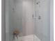 Modern tiled shower with glass door, rainfall shower head and stylish stool at 7922 Spring Valley Dr, Tampa, FL 33615
