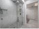 Shower featuring marble tile, a rainfall shower head, and custom shelving at 7922 Spring Valley Dr, Tampa, FL 33615