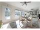 Sunroom with table, chairs, tile floor, and view of the pool at 7922 Spring Valley Dr, Tampa, FL 33615