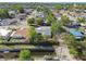 High-angle shot of a home with mature trees, surrounded by green space, canal, and homes in a mature neighborhood at 8003 W Powhatan Ave, Tampa, FL 33615