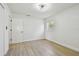 Bright bedroom featuring wood-look floors, white walls, baseboards, modern ceiling fan, and window at 8003 W Powhatan Ave, Tampa, FL 33615