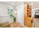 Bright entryway with wood-look floors, a storage closet, and a built-in shelving and counter space at 8012 Savannah Sunset Ln, Tampa, FL 33615