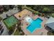 An aerial view showcases a resort-style community pool with a playground and a basketball court at 8306 Red Spruce Ave, Riverview, FL 33578