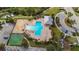 An aerial view showcases a resort-style community pool and amenities, like a playground and basketball court at 8306 Red Spruce Ave, Riverview, FL 33578