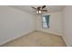 Simple bedroom with a window, wall-to-wall carpet and neutral paint at 8306 Red Spruce Ave, Riverview, FL 33578
